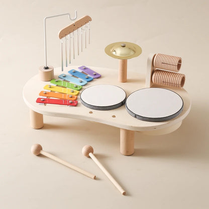 Children's wooden musical toy set on a beige background